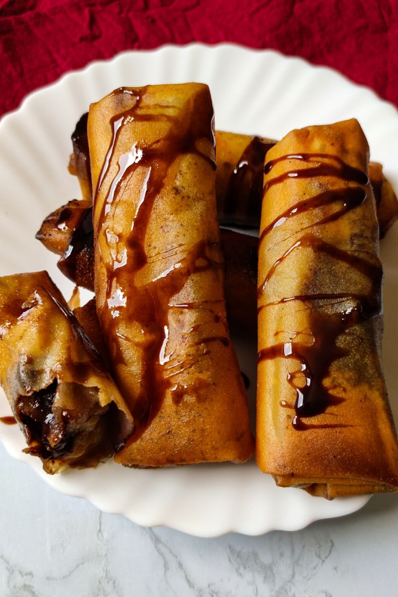 baked chocolate dipped banana spring rolls — crispy, gooey & irresistible