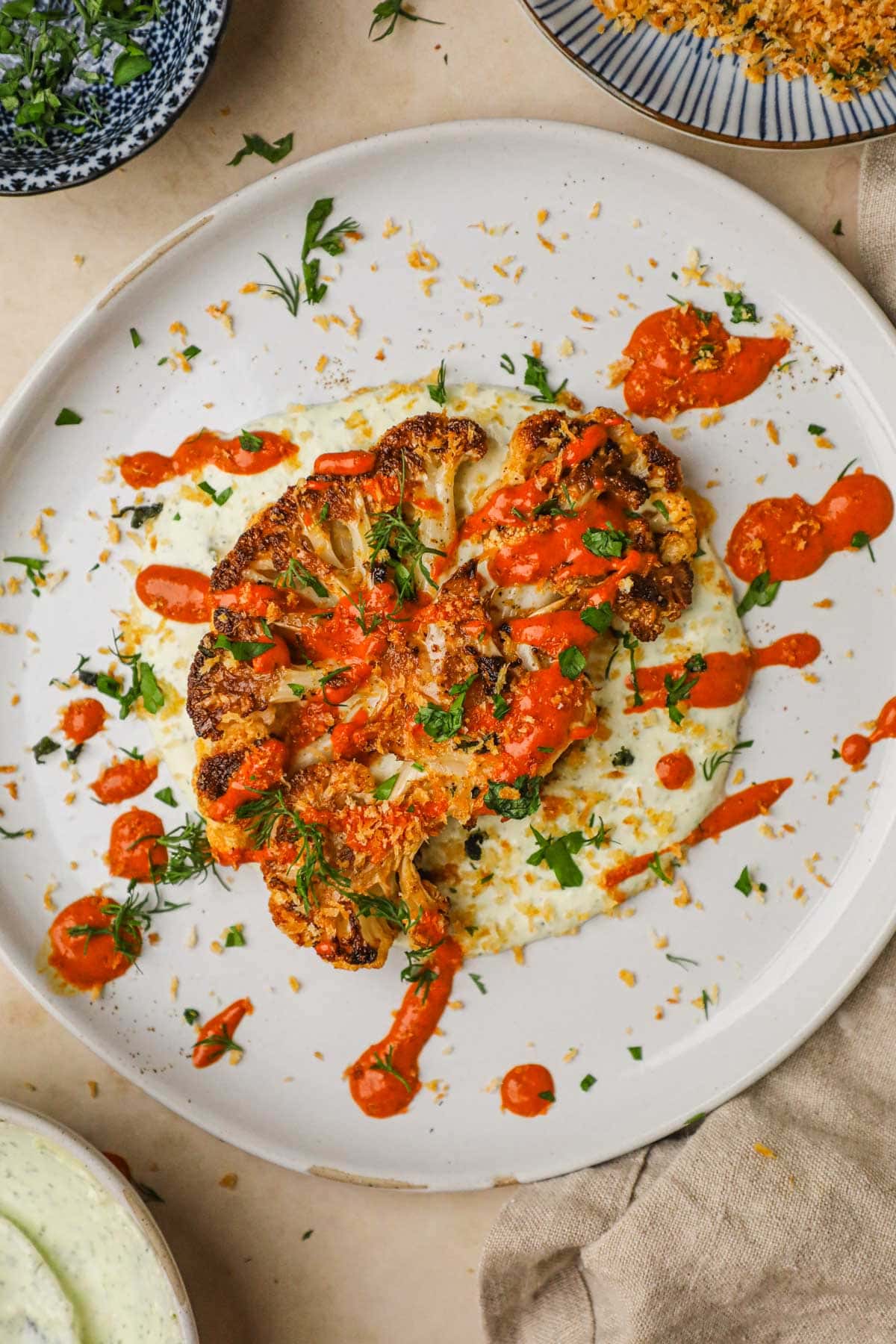 harissa roasted cauliflower steaks — spicy, savoury & tahini drizzled